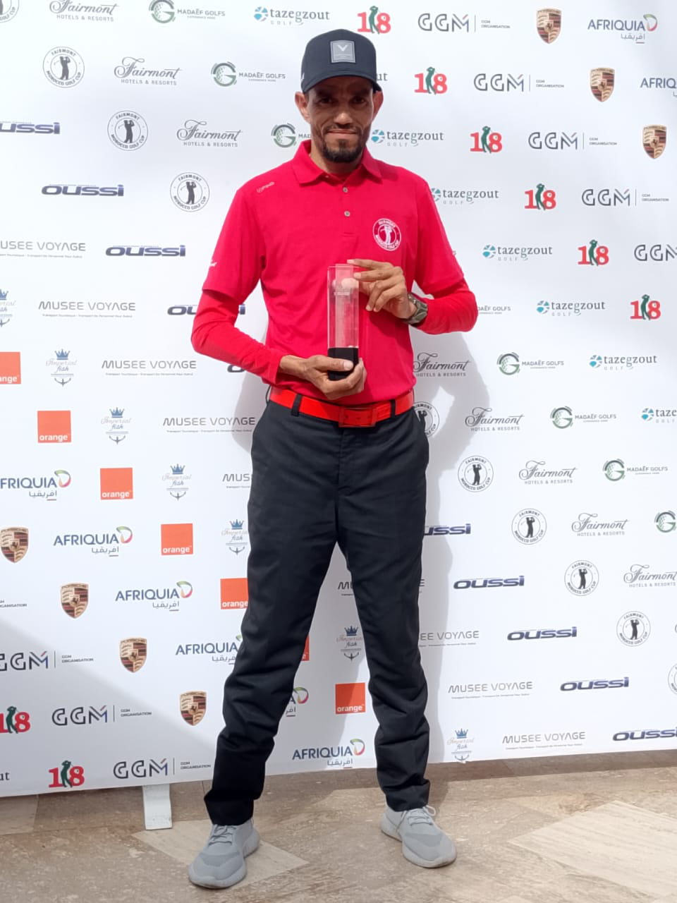 Golf pro holding an award at a golf event